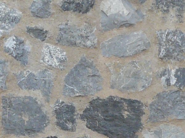 Grey stone set randomly in wall.